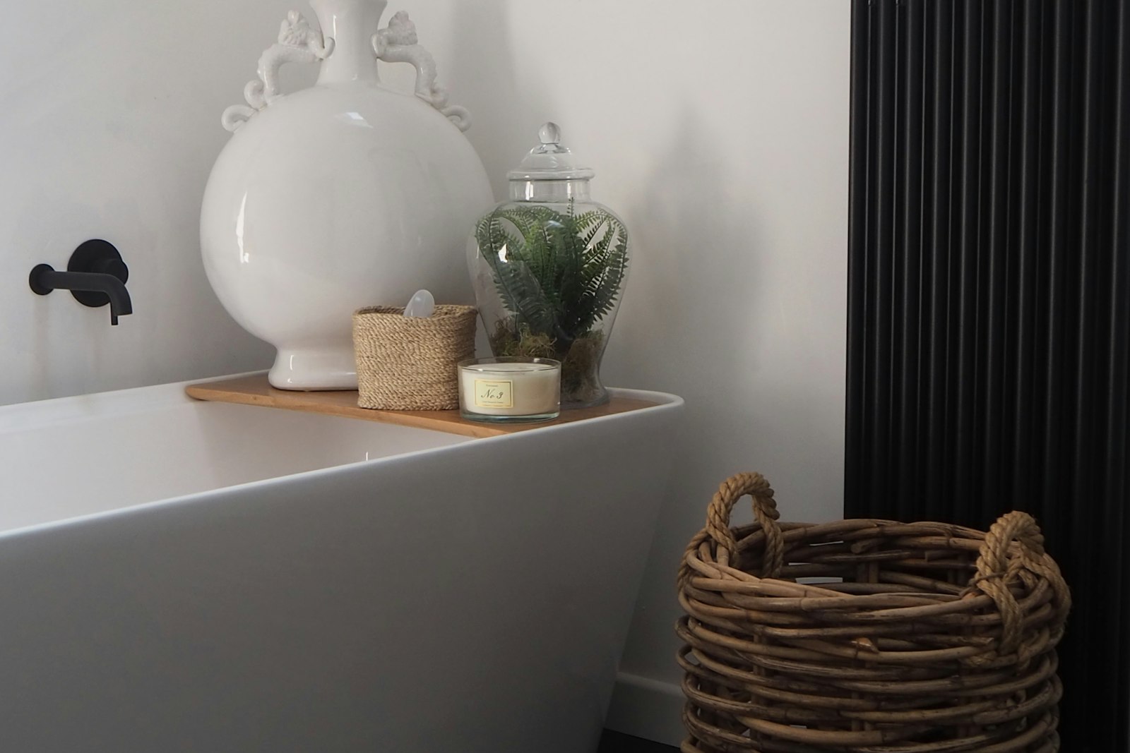 Steam rising over a freestanding tub beside a low lamp